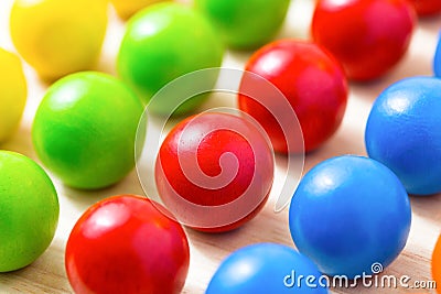 Colored pegs board, wood beads on wooden background. Shallow DOF Stock Photo