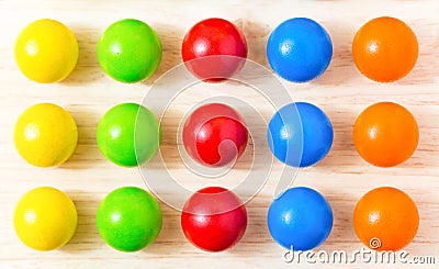 Colored pegs board, wood beads on wooden background. Shallow DOF Stock Photo