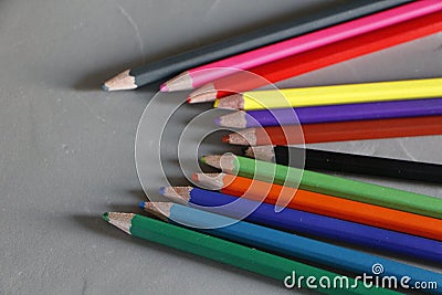 Colored pencils on grey background Stock Photo