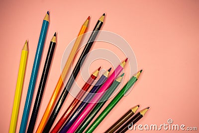 colored pencils lie on a pink background. close up, copy, spacee Stock Photo