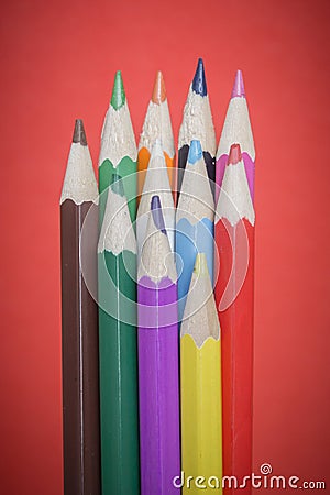 Colored pencils on red background Stock Photo