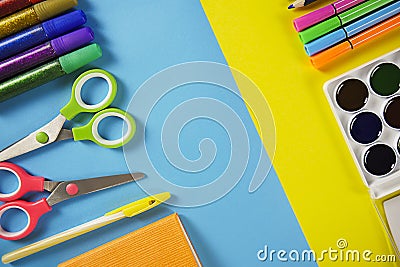 Colored pencils, scissors. School office on a yellow blue background. copy space Stock Photo