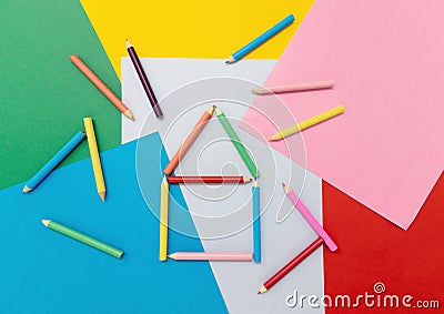 Colored pencils in the shape of a house on colored paper Stock Photo