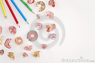 Colored pencils and shavings on white background with copy space Stock Photo