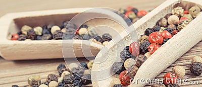 Colored pepper on wooden board as cooking spice Stock Photo