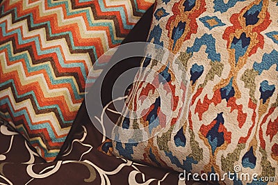 Colored pillow with pattern on bed. Rest, sleeping, comfort concept Stock Photo
