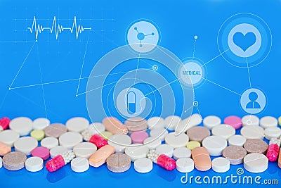 Colored pills on a blue background. Medical concept. Stock Photo