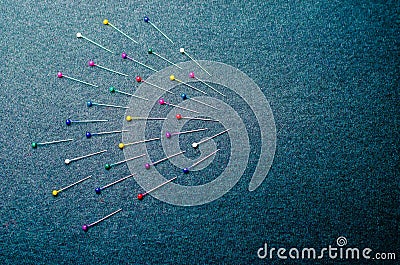 Colored pins on a dark background Stock Photo