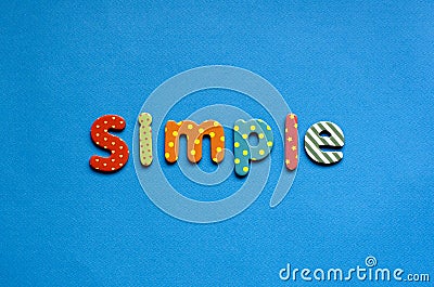 colored text simple on blue paper background. Stock Photo