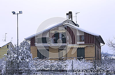 Colored vintage house with a snowy roof - Winter snow Stock Photo