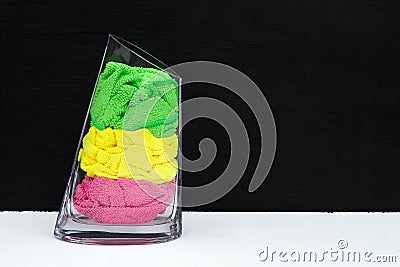 Colored washcloths in a glass vase Stock Photo