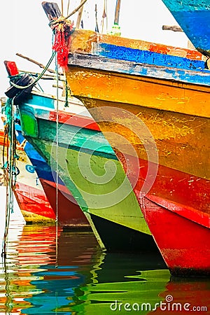 Colored water reflections . Colorful boats in the seaport . Stock Photo