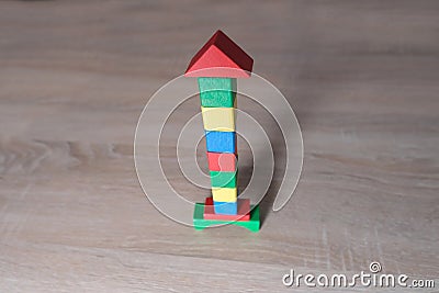 Colored wooden cubes, builds houses and rockets, the concept of the development of creativity, fine motor skills, patience and Stock Photo