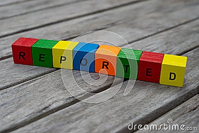 Colored wooden cubes with letters. the word reported is displayed, abstract illustration Cartoon Illustration