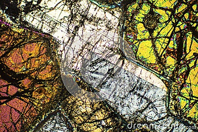 Colorful, abstract pattern of mineral in a polarizing micrograph. Stock Photo