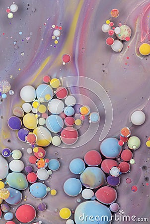 Colorful abstract patterns created by floating droplets in vibrant liquids on a smooth surface Stock Photo
