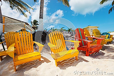 Colorful adirondack lounge chairs at Caribbean beach Stock Photo