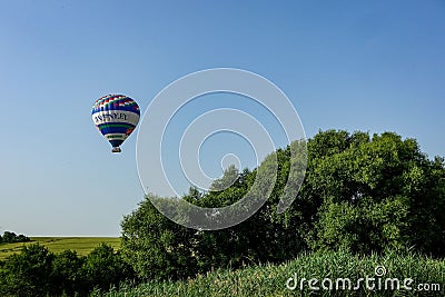 Colorful air balloon flies over the city suburbs. Editorial Stock Photo