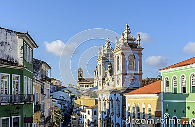 Colorful and ancient colonial houses facades and historic church towers in baroque and colonial style Stock Photo