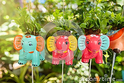 Colorful animal ceramic doll hanging in the garden. Stock Photo