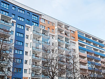 Colorful Apartment Building with Bare Trees Stock Photo