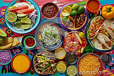 A colorful and appetizing top view of Mexican festive food for Independence Day, featuring chili, cilantro, tacos, burritos, Stock Photo