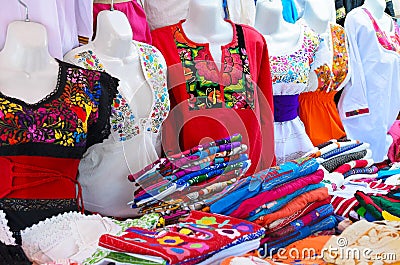 Colorful authentic Mexican women blouses on manekens at the mark Stock Photo