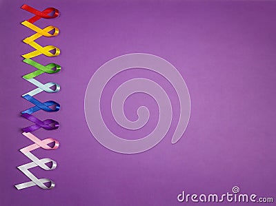 Colorful awareness ribbons on purple background. World cancer day concept, February 4. Stock Photo