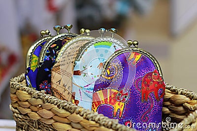 Colorful bags for money with a metal clasp are in a wicker basket Stock Photo