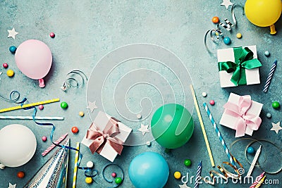 Colorful balloon, present or gift box, confetti, candy and streamer on vintage turquoise table top view. Birthday background. Stock Photo