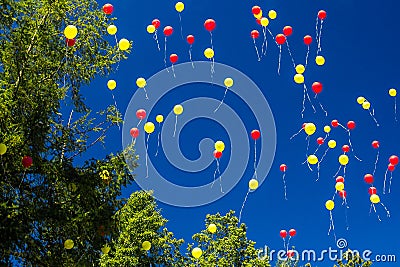 Colorful balloons fly into the blue sky Stock Photo