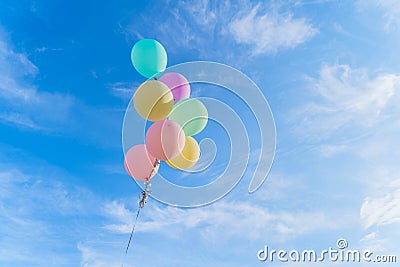 Colorful balloons isolated on clear blue sky background in happy birthday, celebration party concept Stock Photo