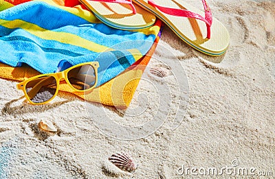 Colorful beach towel, sunglasses and thongs Stock Photo