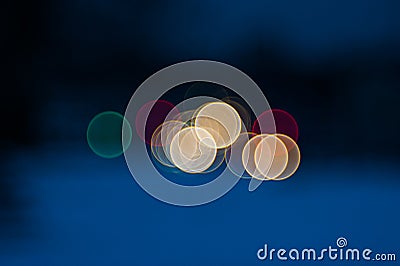 Colorful beautiful blurred bokeh background with copy space. Festive texture. Brilliant multicolored light spots on a dark blue Stock Photo