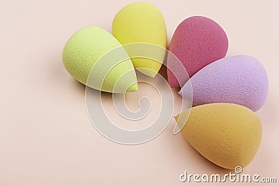 Colorful beauty sponges on pink background. Copy space. Stock Photo