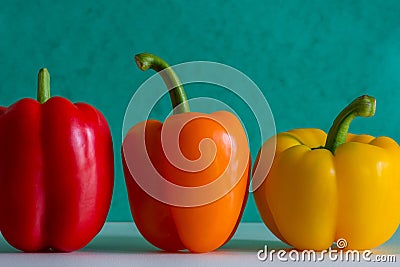 Colorful bell peppers in front of a colorful background Stock Photo