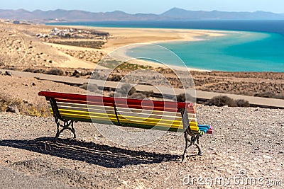 Colorful bench to contemplate View in Playa de Sotavento, Fuerteventura in Spain in summer Stock Photo