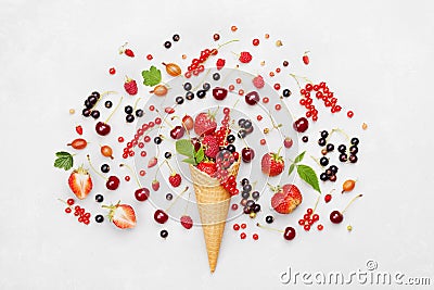 Colorful berries in waffle cone on light background from above. Dietary and healthy dessert. Flat lay styling. Stock Photo