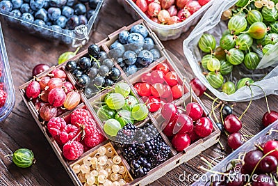 Colorful berries in wooden crate on the table. Top view Stock Photo