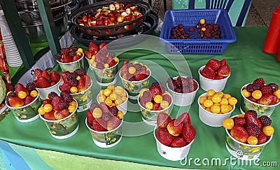 Colorful berry fruit bowls on a green table at a market stall, Medellin, Colombia Stock Photo