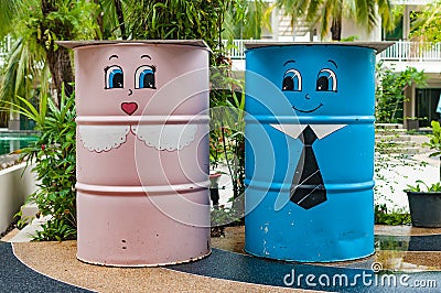 Colorful bin in a garden with cartoon painted Stock Photo