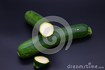 Colorful bio fresh green zucchini on black background Stock Photo