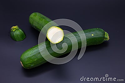 Colorful bio fresh green zucchini on black background Stock Photo