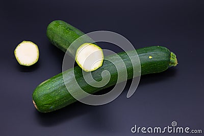 Colorful bio fresh green zucchini on black background Stock Photo