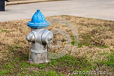 Colorful Blue and Silver Fire Hydrant used for supplying water Stock Photo