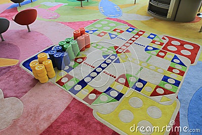 A colorful board game includes dice. pawns, playing cards and credits. 16 April 2011 Editorial Stock Photo
