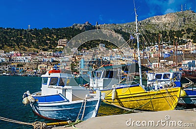 Colorful boats: blue-white and yellow in Greek port Stock Photo