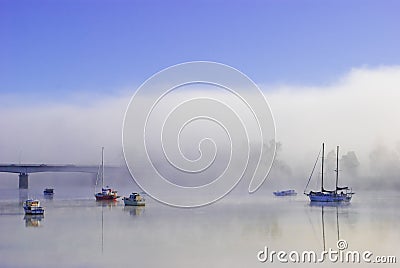 Colorful boats on a foggy river Stock Photo