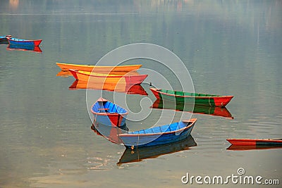 Colorful boats and their reflections on phewa lake Stock Photo