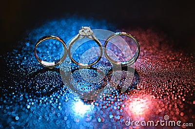 Colorful with bokeh beautiful three wedding rings with diamond, Celebration of engagement Stock Photo